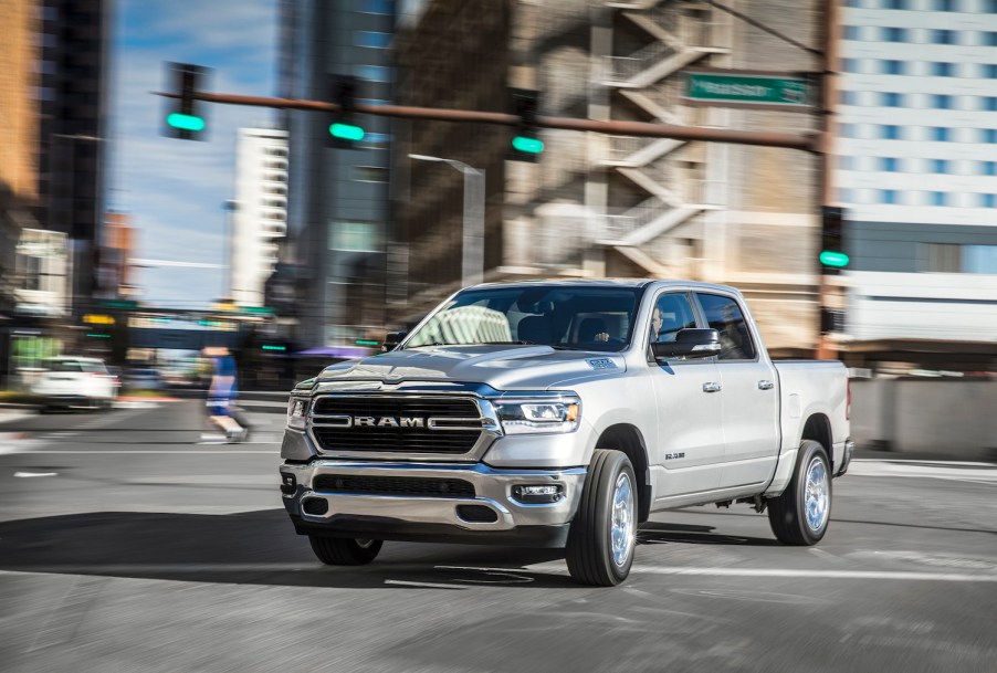 A white 2022 Ram 1500 parked in a city.