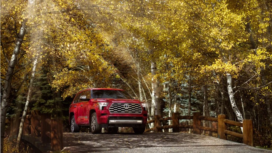 Red 2023 Toyota Sequoia Capstone in the woods moonroof