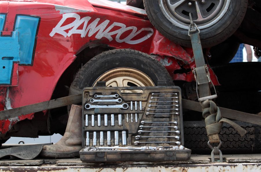 A car tool kit next to a red race car