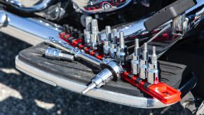 A selection of tools on a motorcycle foot board