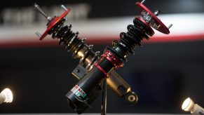 A set of black-red-and-gold Blitz coilovers at the 2017 Tokyo Auto Salon