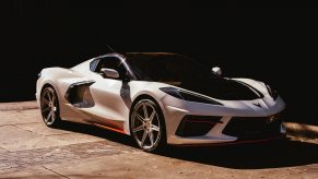 A white C8 Chevrolet Corvette shot half in the sun and half in the shade from the 3/4 angle