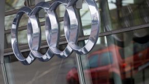 A chrome Audi logo on a glass background.