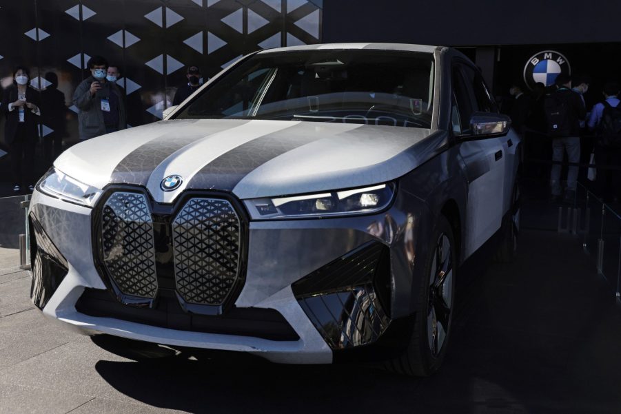 A grey and black BMW color-changing car displayed indoors with a black and grey background.