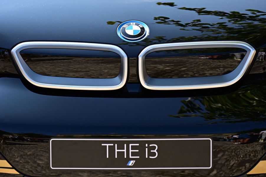 The front end of a blue BMW i3 with the grille and logo displayed and a plate that reads 'THE i3.'