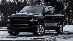 Black 2022 Ram 1500, which offers a deal to save money in Winter 2022, according to U.S. News, parked on snowy road