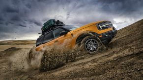 Cyber Orange 2022 Ford Bronco Sport driving up a hill