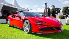 A red Ferrari SF90 Stradale at Salon Prive in the United Kingdom's Concours d'Elegance