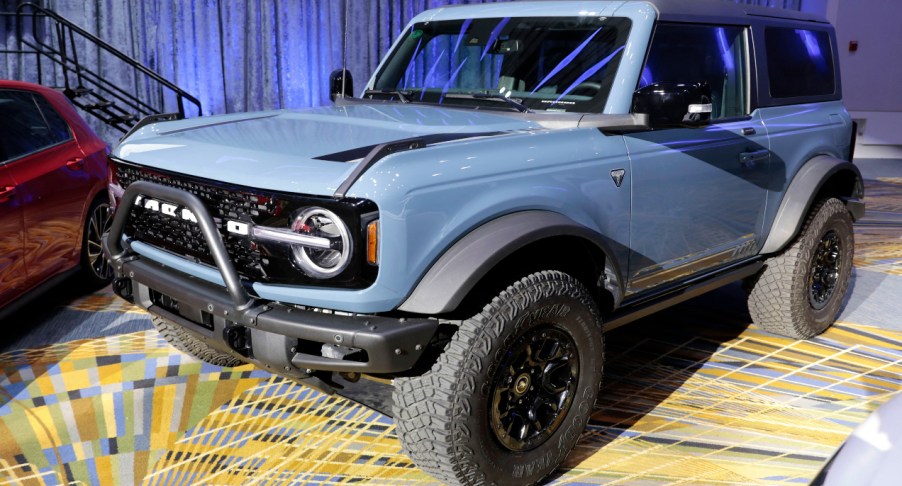 A blue Ford Bronco is on display.