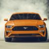 Front view of orange 2022 Ford Mustang, one of the cheapest sports cars