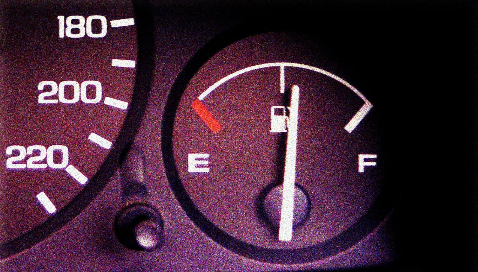 A black gas gauge to assist in monitoring car fluids showing a half a tank. 