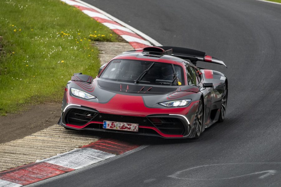 A Mercedes-AMG One supercar clipping the apex of a corner at the Nurburgring race track in Germany