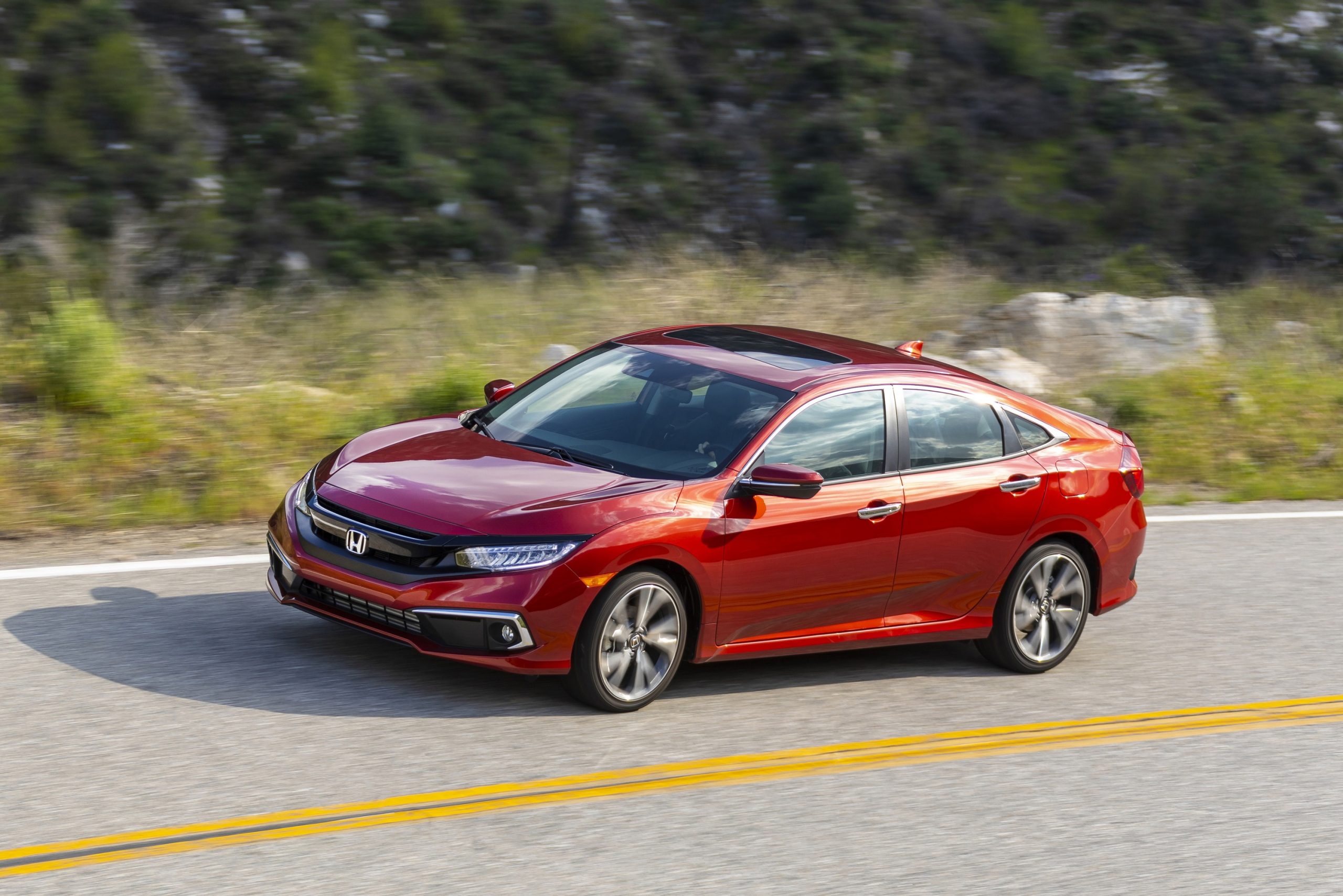 A candy red Honda Civic like this one, shot from the 3/4 angle, makes for an amazing cheap used car.