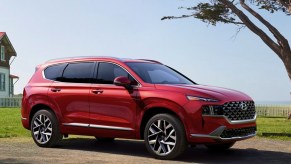 A red Hyundai Santa Fe is parked outdoors.