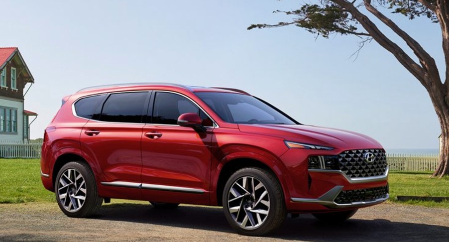 A red Hyundai Santa Fe is parked outdoors.