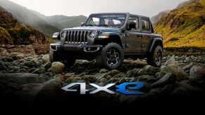 A black 2022 Jeep 4xe driving over rugged terrain.