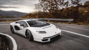 A white Lamborghini Countach LPI 800-4 corners on a mountain road