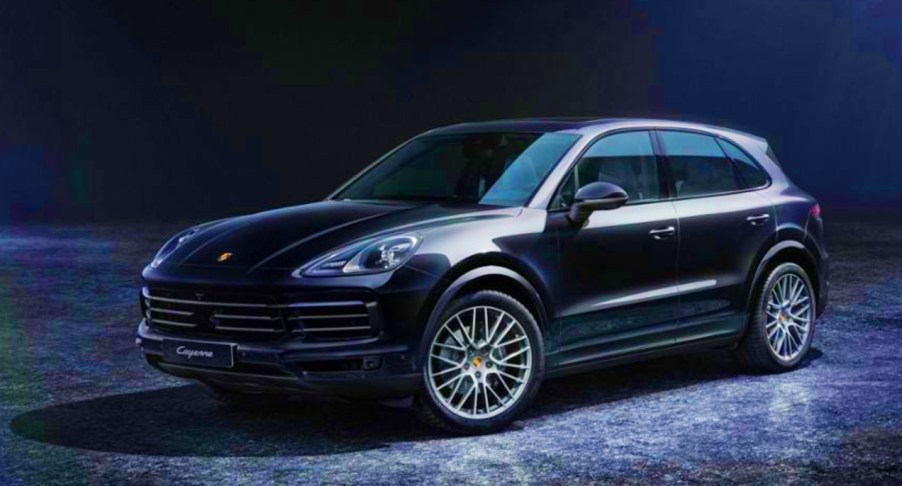 A black Porsche Cayenne Platinum Edition luxury SUV is parked.