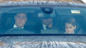 Prince William driving and Prince George in the passenger seat on the way to a Christmas lunch for royal family members in London, United Kingdom (U.K.)