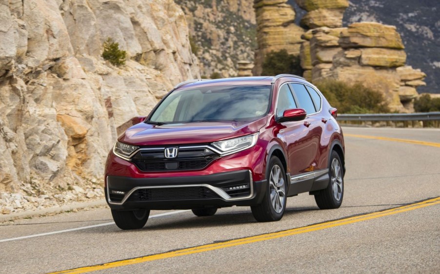 Radiant Red Metallic 2022 Honda CR-V driving by rock formations