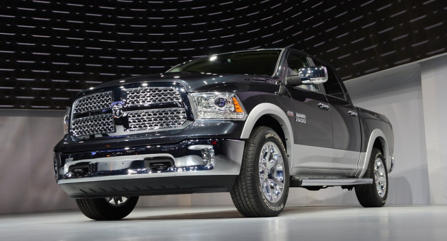 A black Ram 1500 truck is on display.