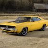 A yellow 1969 Dodge Charger restomod with a Hellcat V8 shot from the 3/4 angle