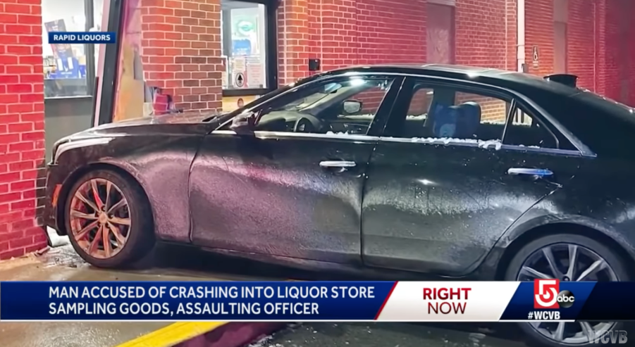 news camera footage showing black Cadillac crashed into a liquor store