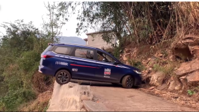 Man doing a crazy U-turn on the side of cliff