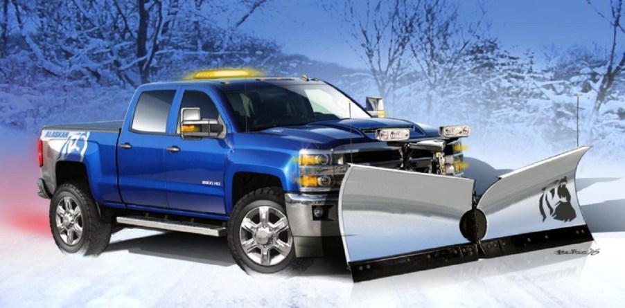 A blue Chevy Silverado with a snowplow.