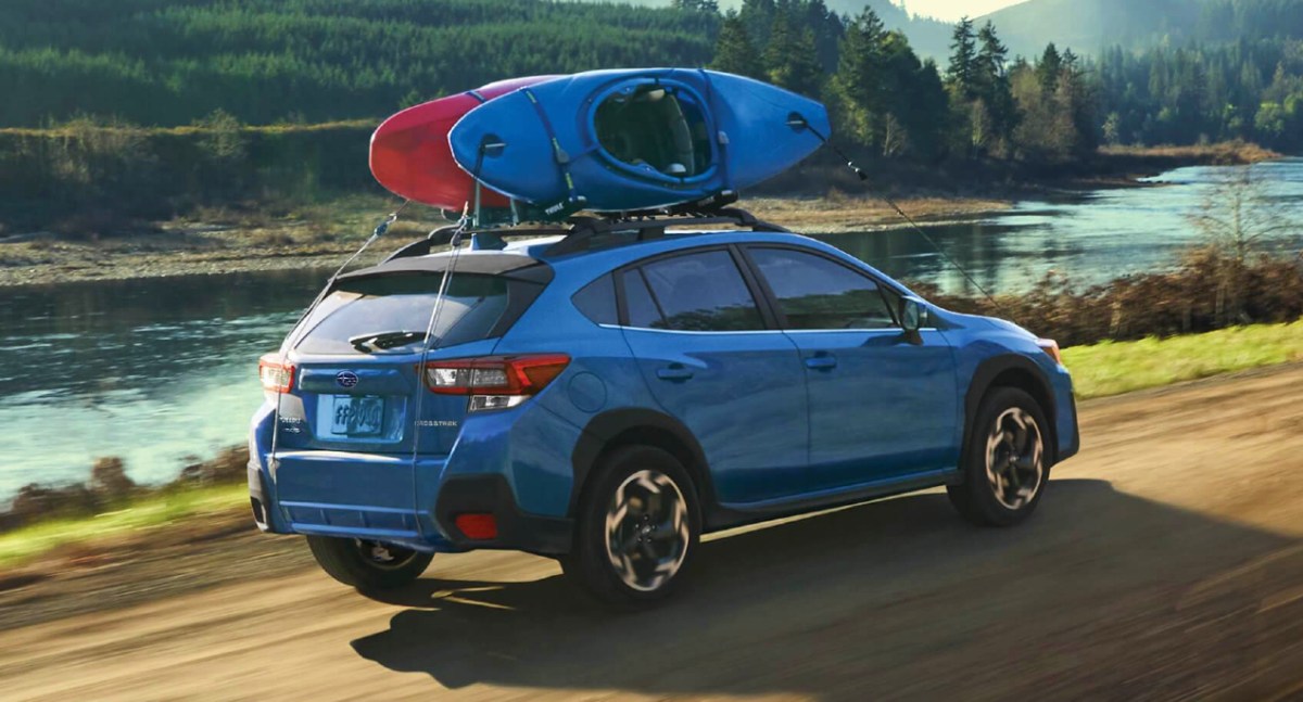 A blue Subaru Crosstrek compact SUV is driving off-road.