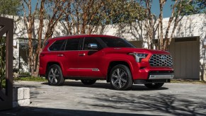 Supersonic Red 2023 Toyota Sequoia Capstone parked in front of trees