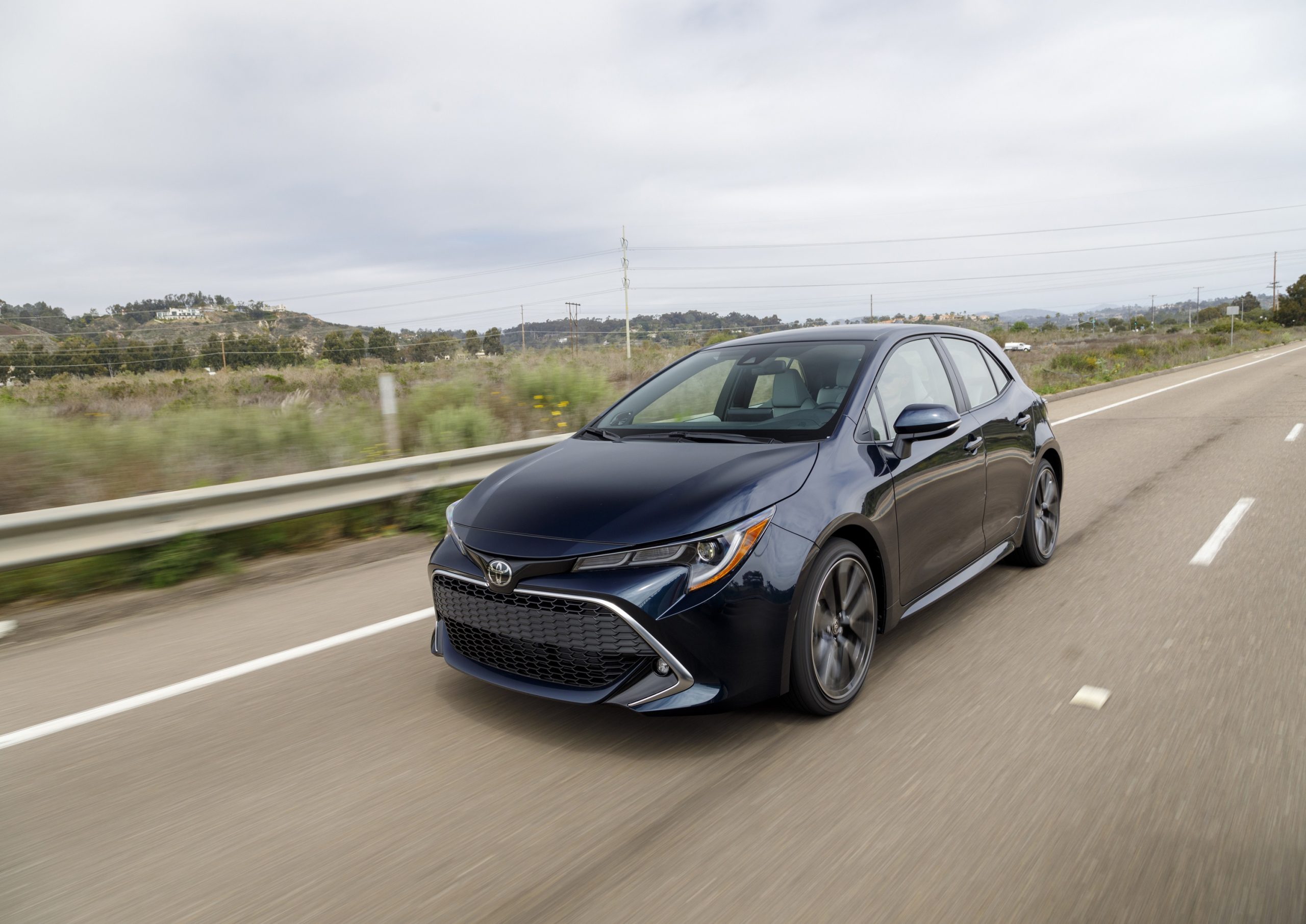 A dark blue Toyota Corolla hatchback shot from the front 3/4