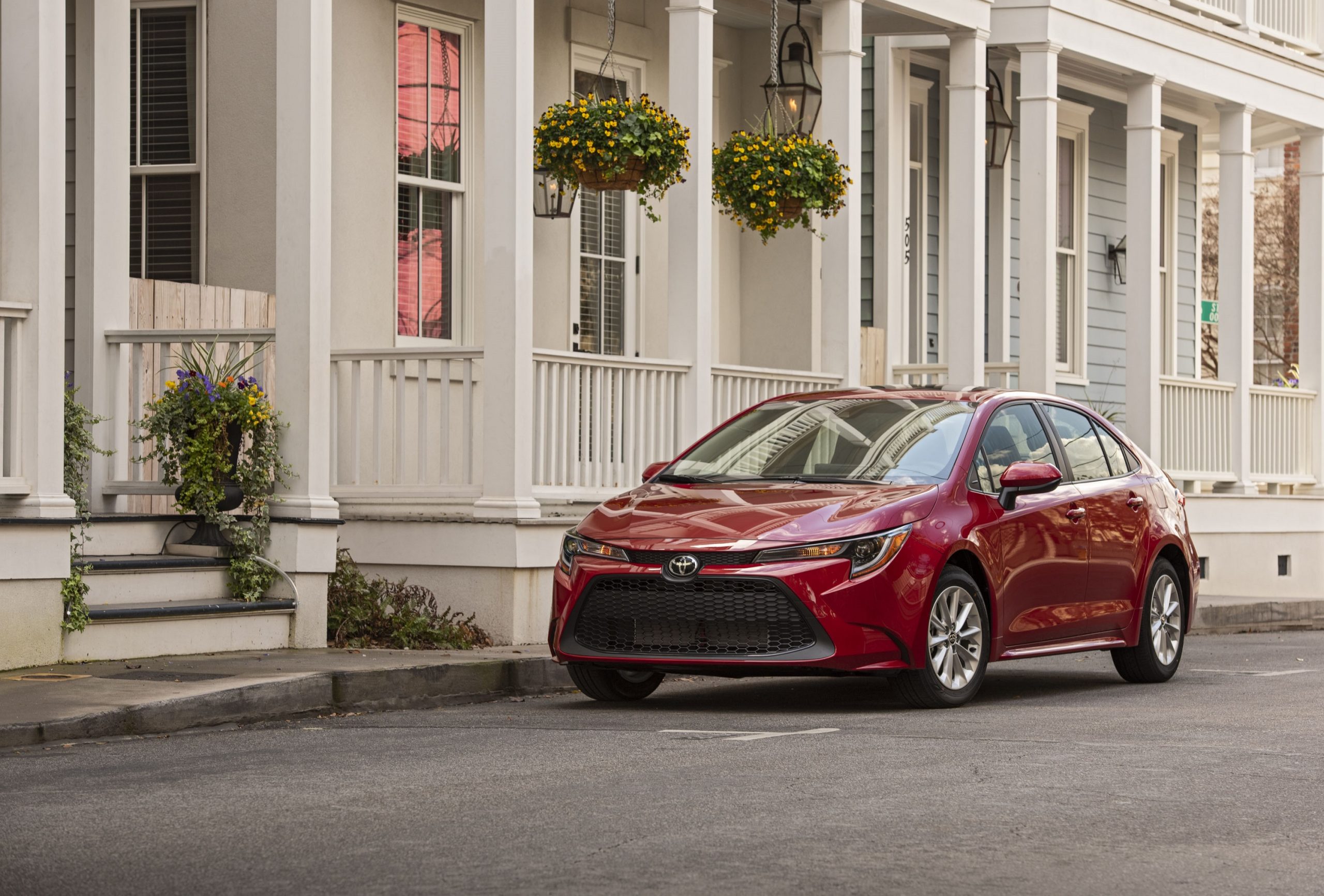 The Toyota Camry, one of the best used cars to buy, shot here from the front 3/4 in red paint