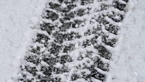 The tracks left by a car tire in the snow