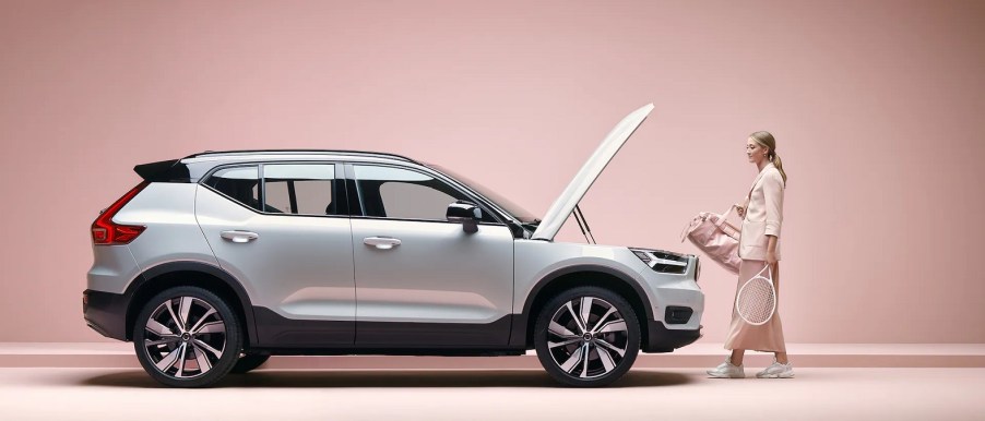 A silver 2022 Volvo XC40 Recharge against a pink background.