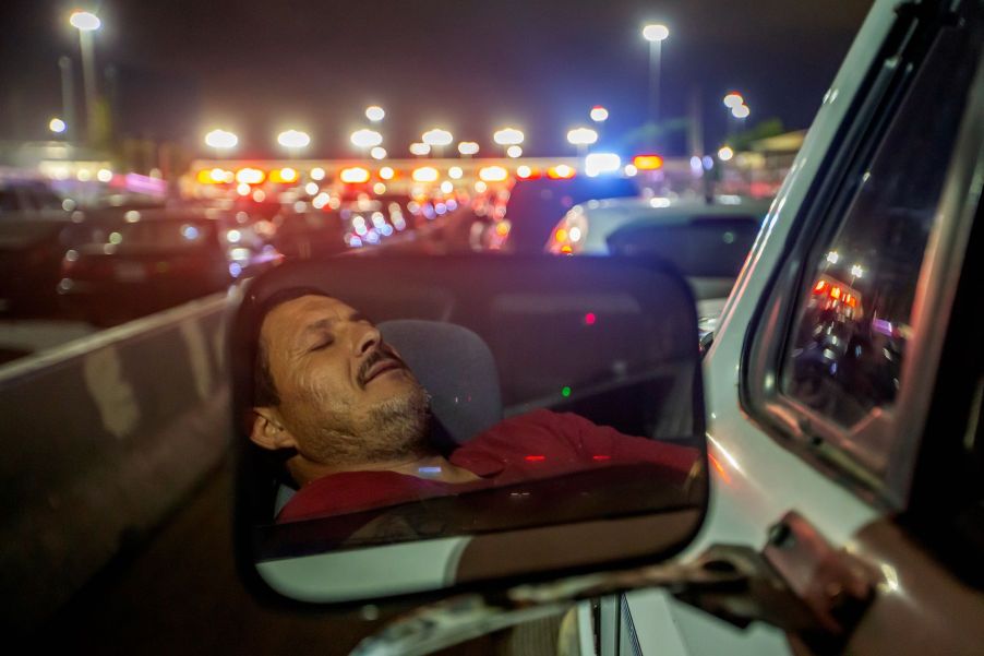 A man sleeping/passed out behind the wheel during a traffic stop slowdown in Tijuana, Mexico