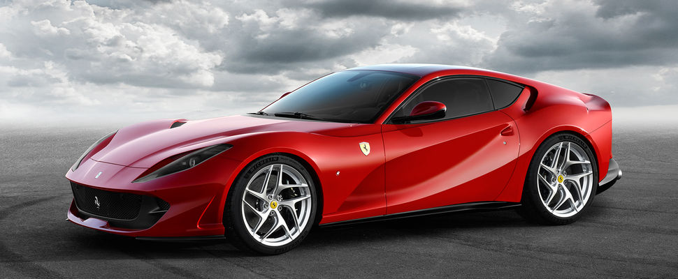 A red Ferrari 812 in front of a cloudy sky background