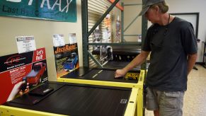 Scott Galassini comparing truck bed covers at Truck Logic in Sheridan, Colorado