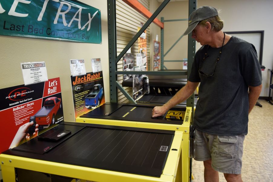 Scott Galassini comparing truck bed covers at Truck Logic in Sheridan, Colorado