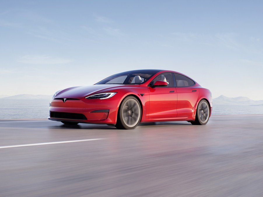 Red 2021 Tesla Model S Rolling Shot of Front Driver Side Fender