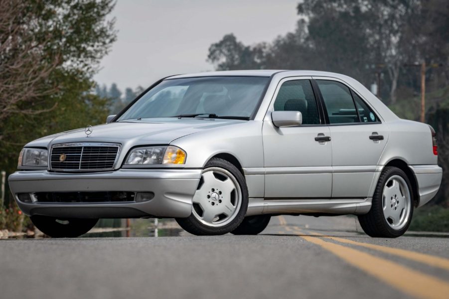 A silver 1998 Mercedes C43 AMG parked on a road