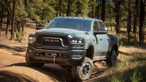 Blue Dodge Ram 4x4 pickup truck parked on an off-road trail.