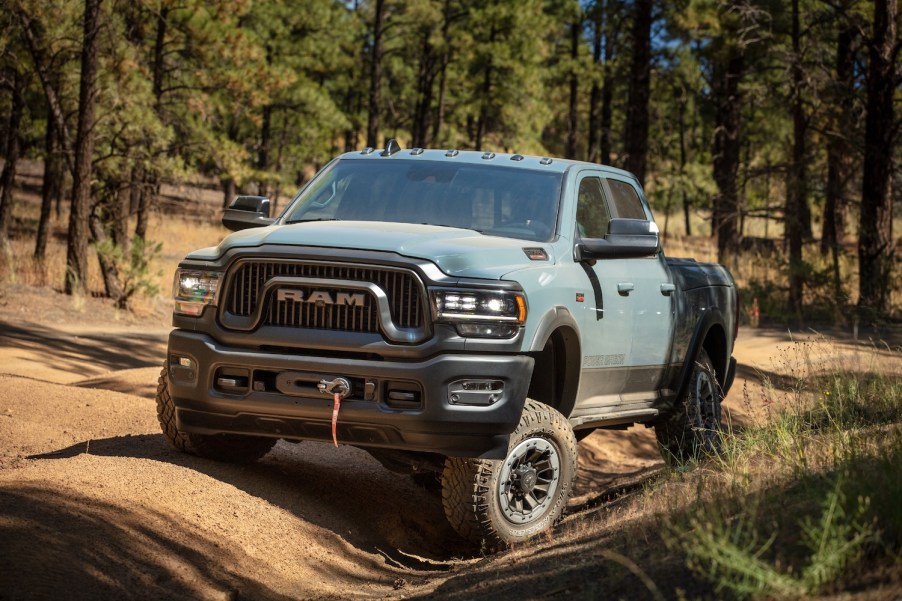 Blue Dodge Ram 4x4 pickup truck parked on an off-road trail.