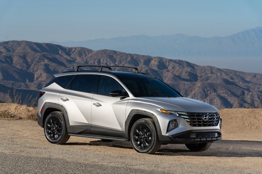 A silver 2022 Hyundai Tucson XRT parked in front of mountains