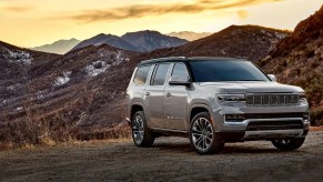 A taupe 2022 Jeep Grand Wagoneer parked outside mountains.