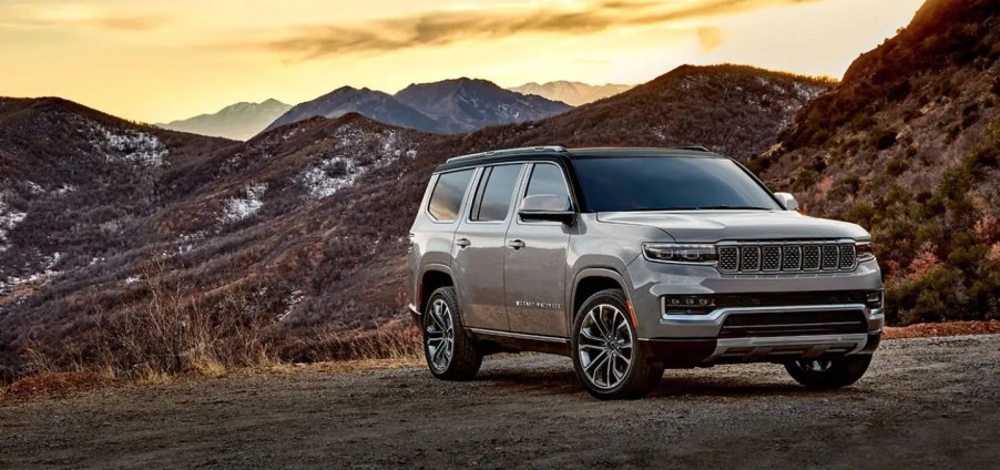 A taupe 2022 Jeep Grand Wagoneer parked outside mountains.