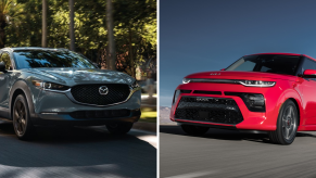 A light blue 2022 Mazda CX-30 driving past trees in a suburb and a red 2022 Kia Soul driving down a highway