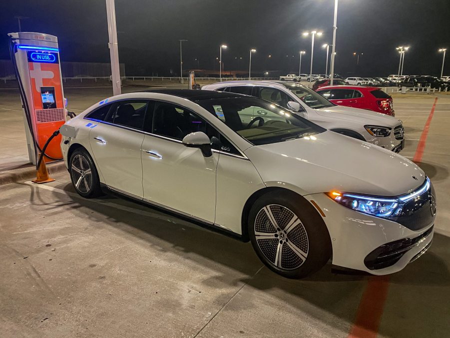 A white 2022 Mercedes-Benz EQS 450+ Premium at a Mercedes dealership's ChargePoint charger