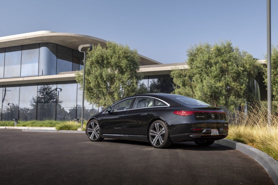 The rear 3/4 view of a black street-parked 2022 Mercedes-Benz EQS 450+