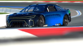 Prototype of a NASCAR Next Gen car testing at high speeds on a race track.